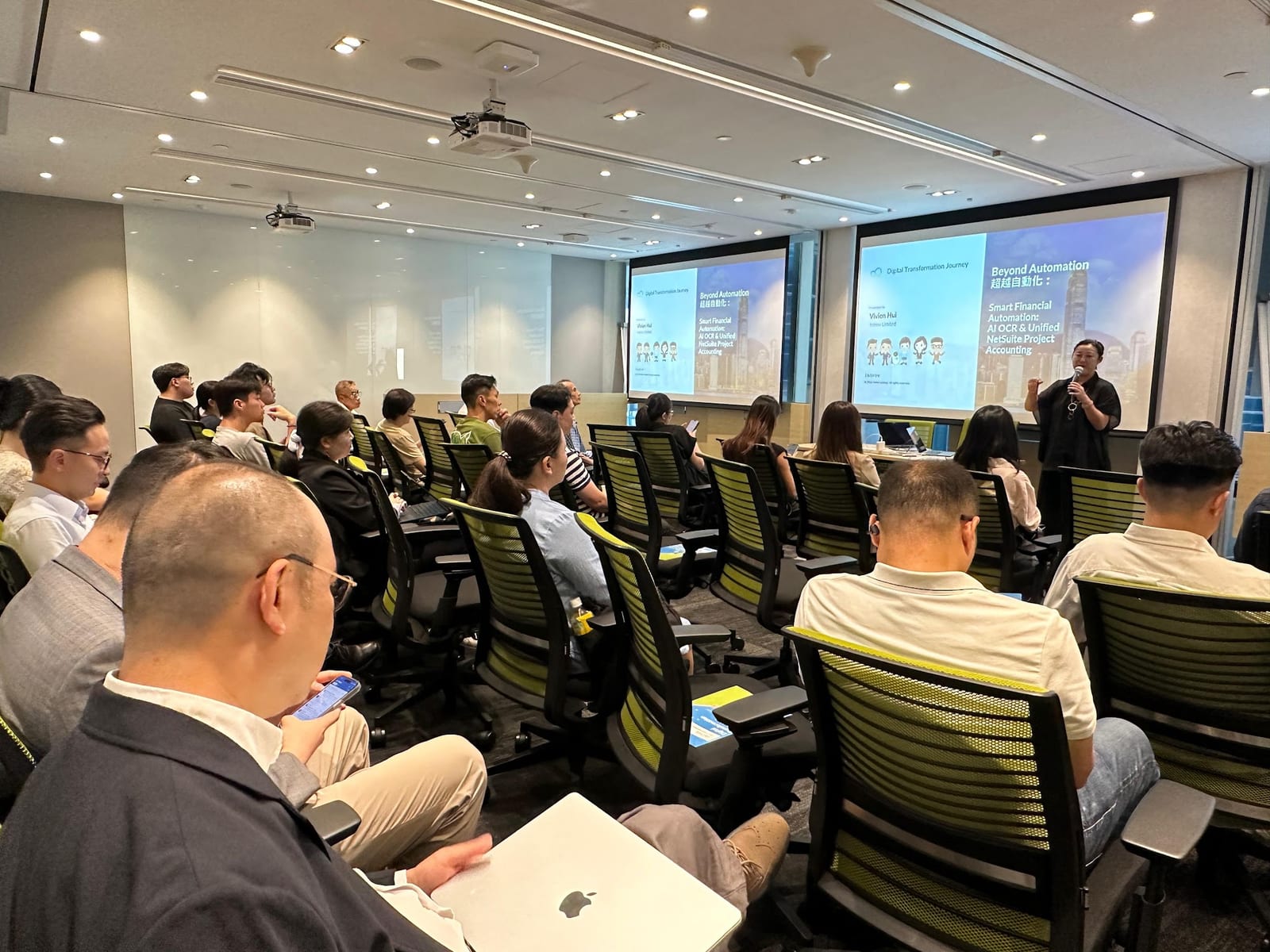 Vivien Hui of Introv presenting Smart Financial Automation: AI OCR and Unified NetSuite Project Accounting to AEC finance and IT leaders at Oracle's Hong Kong headquarters.